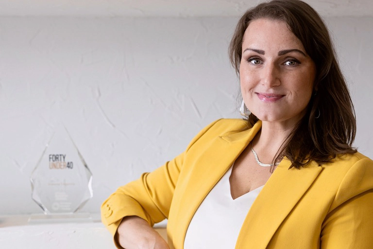 Shawna Tregunna wearing a yellow blazer over a white shirt, exuding confidence and style in a professional setting.